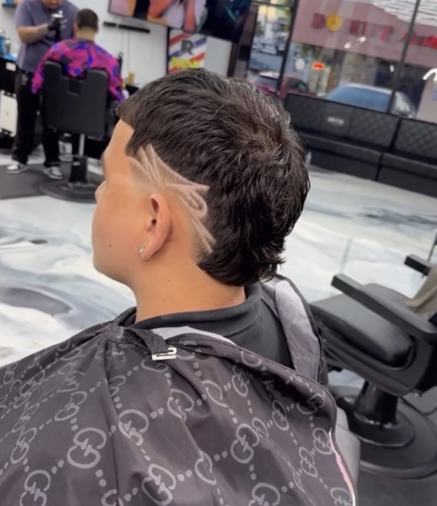 Mullet haircut with custom shaved design