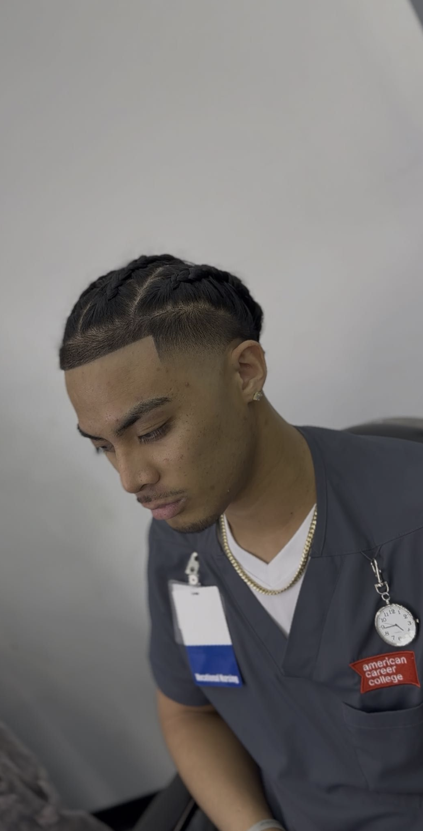 Braided haircut with sharp lineup and fade